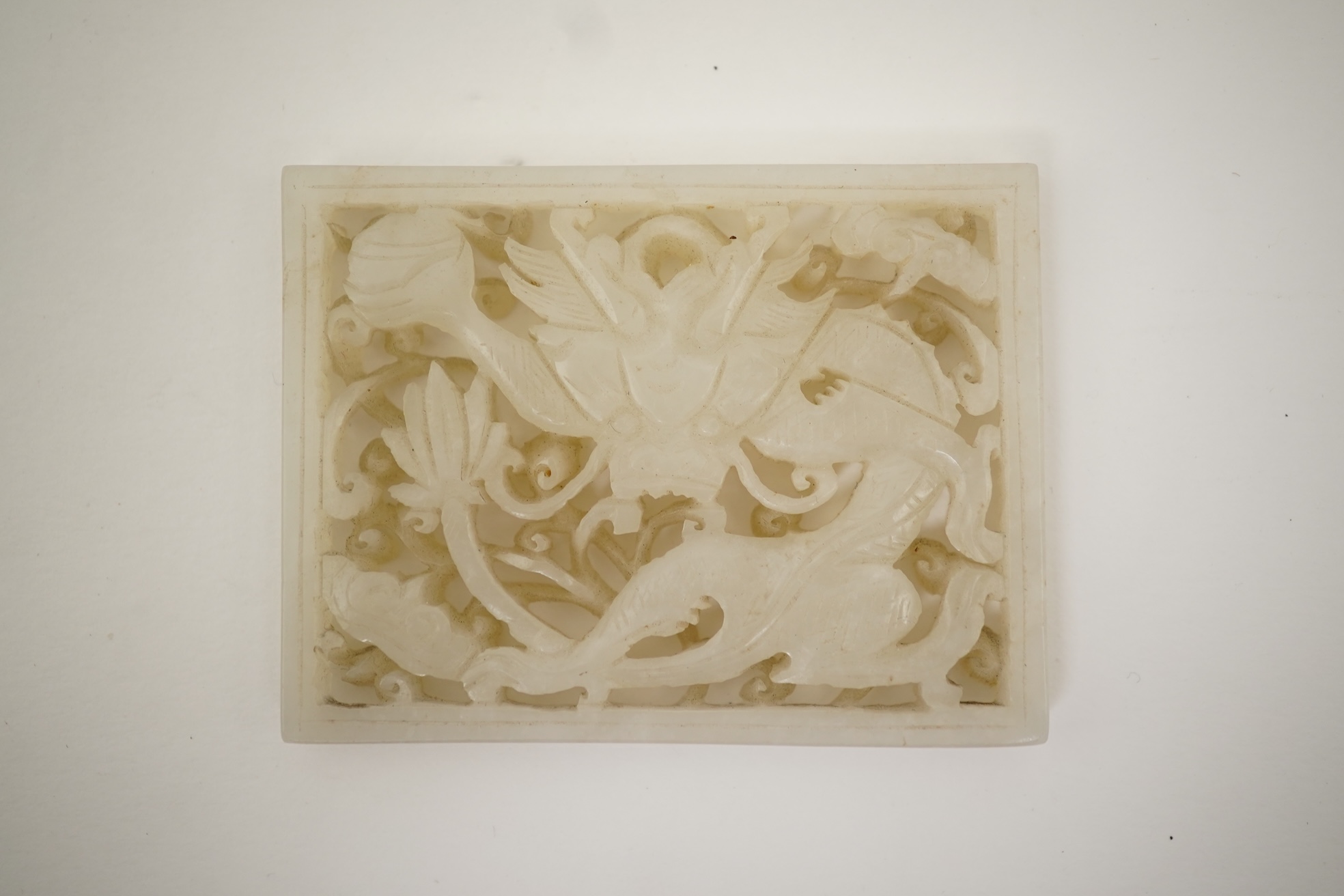 A Chinese reticulated white jade ‘dragon’ plaque, 18th century